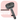 A handheld black electronic pet grooming brush featuring fine metal bristles and a central misting nozzle. The ergonomic handle includes a power button and a USB-C charging port. The device is displayed against a soft pink background with the text "PurrPurr Mist-Groomer: Safe for Cats & Dogs and boosts skin health."