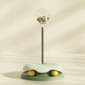 "Green 2-in-1 interactive cat toy with treat dispenser and spinning turntable"
